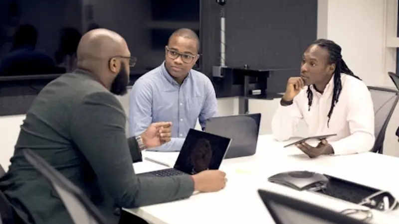 Male professionals analyzing data and generating reports using advanced Request for Proposal (RFP) software analytics tools